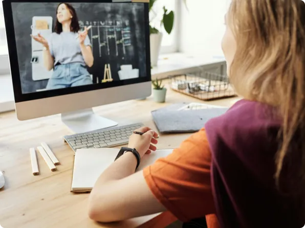 Student attending a live online class at her desk