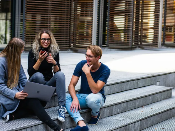 Students chatting on campus steps between classes