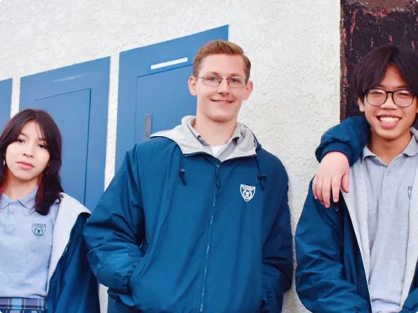 Three SOA students standing together outside school